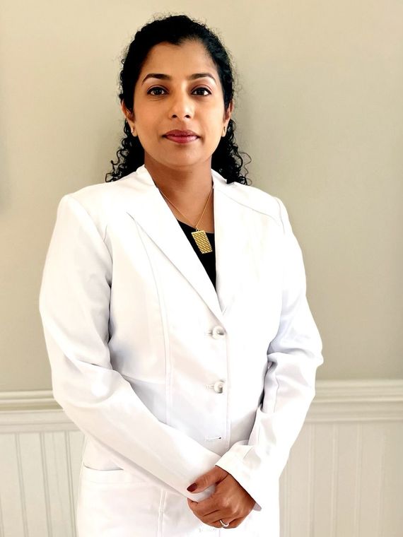 Dr. Ramya Rangaraj in a white coat at the Cumming office